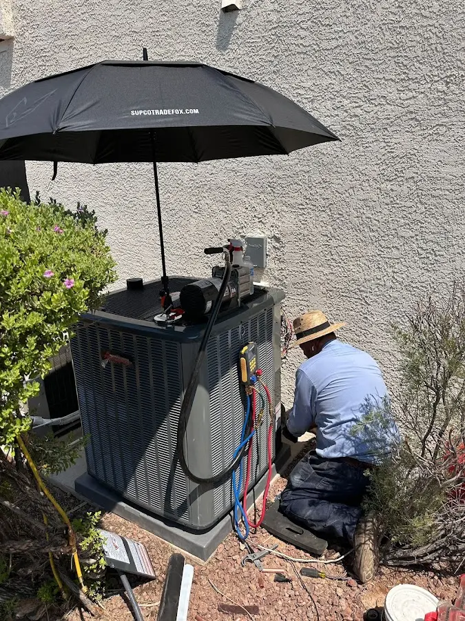 HVAC technician performing outdoor AC maintenance in Hartford